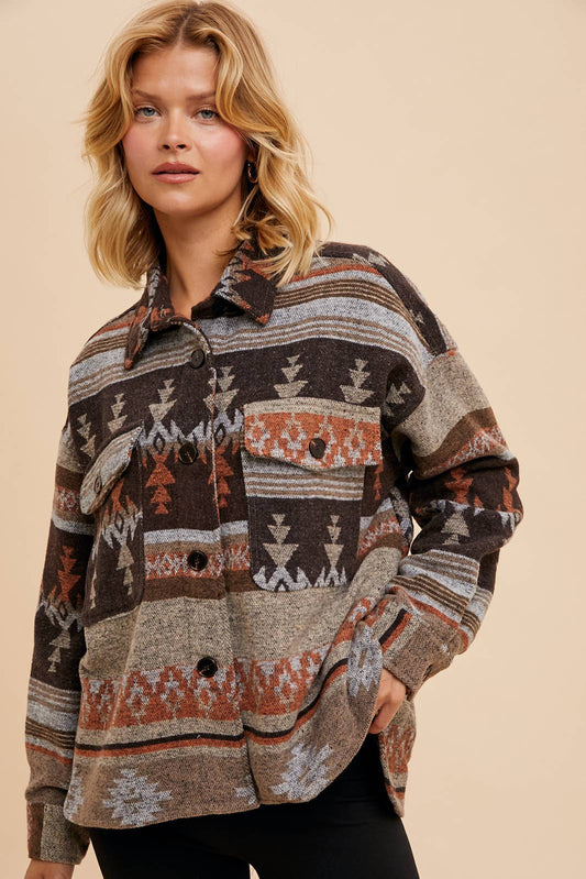Woman wearing a patterned shirt against a beige background