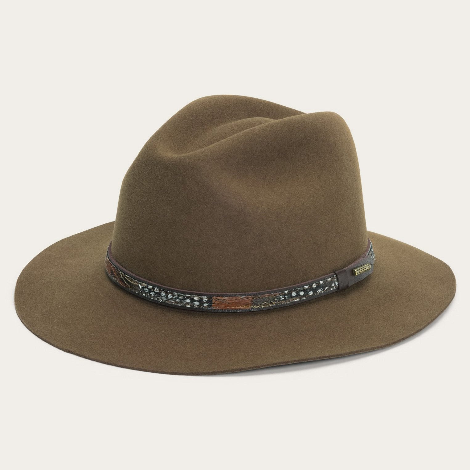 Brown fedora hat with a decorative band on a white background