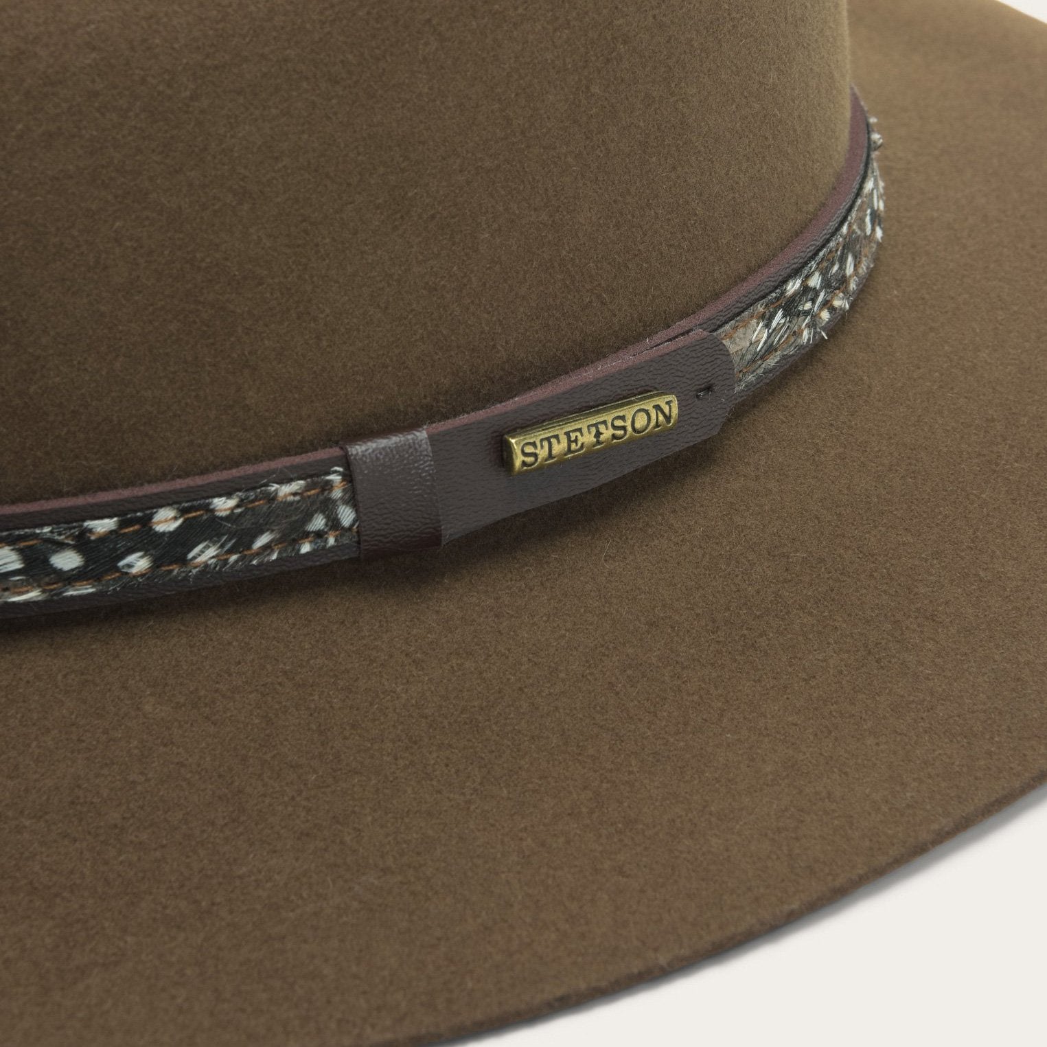 Brown Stetson hat with a decorative band on a white background