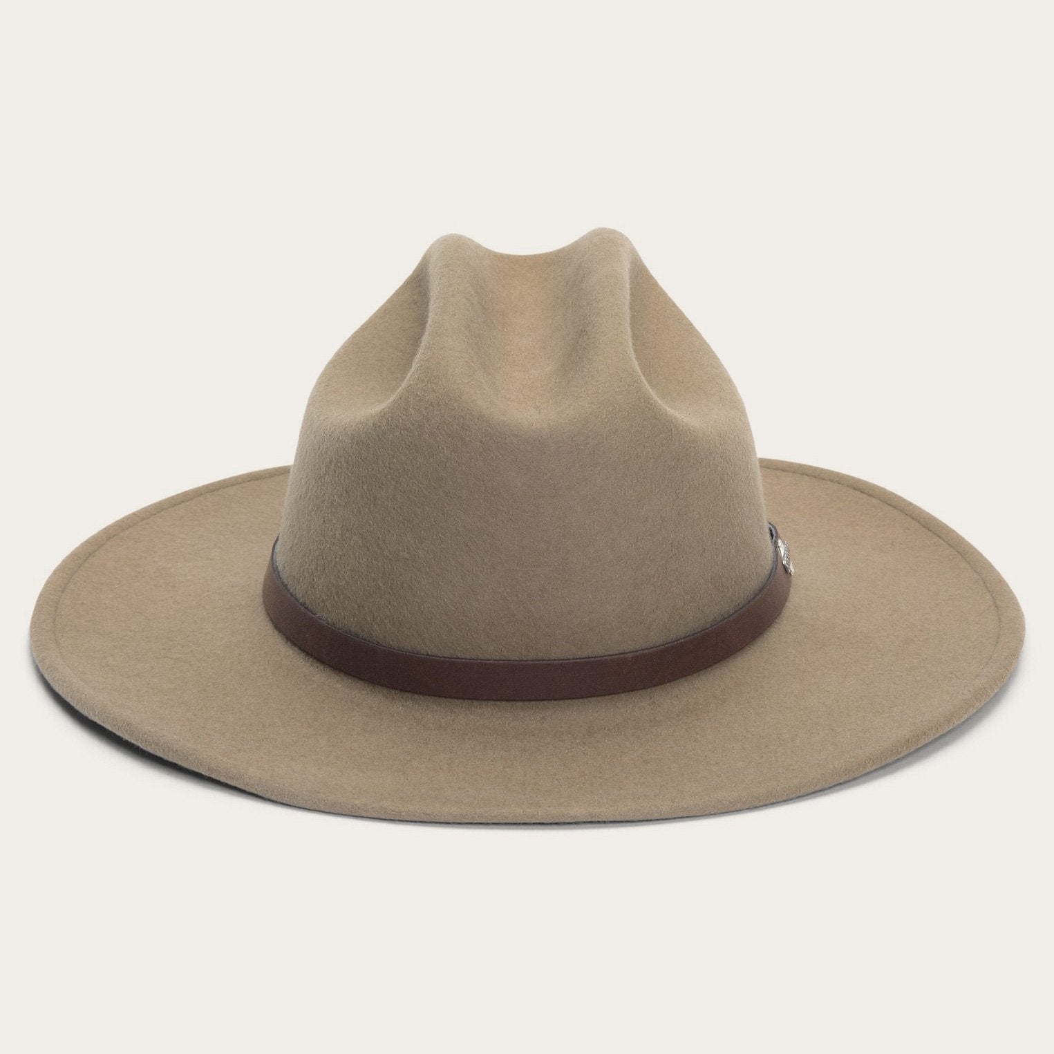 Beige cowboy hat with a brown band on a light gray background