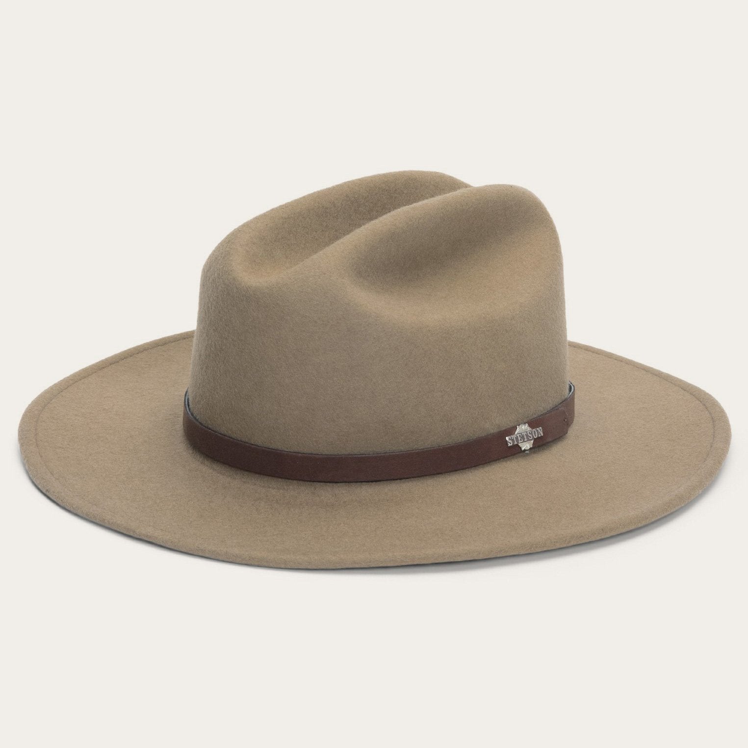 Beige cowboy hat with a brown band on a white background
